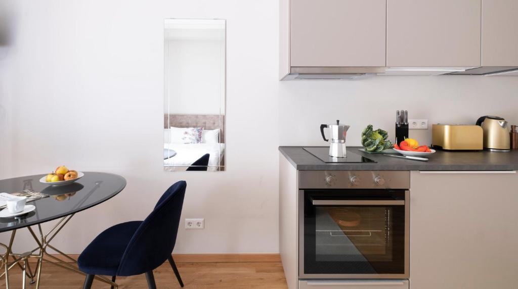 a small kitchen with a table and a stove at Central and new designer flat - Yael's apartments - Charlottenburg by Arbio in Berlin