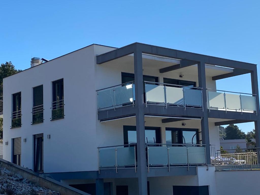 a white building with balconies on it at Villa Sun&Sea in Komarna