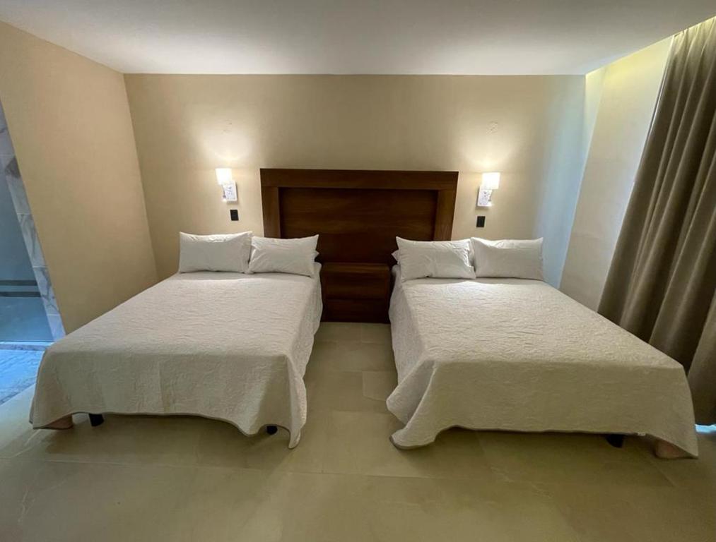 Postel nebo postele na pokoji v ubytování Hotel Balcón del Cielo