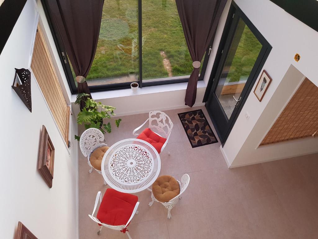 an overhead view of a balcony with a table and chairs at Calme et Nature in Rouen