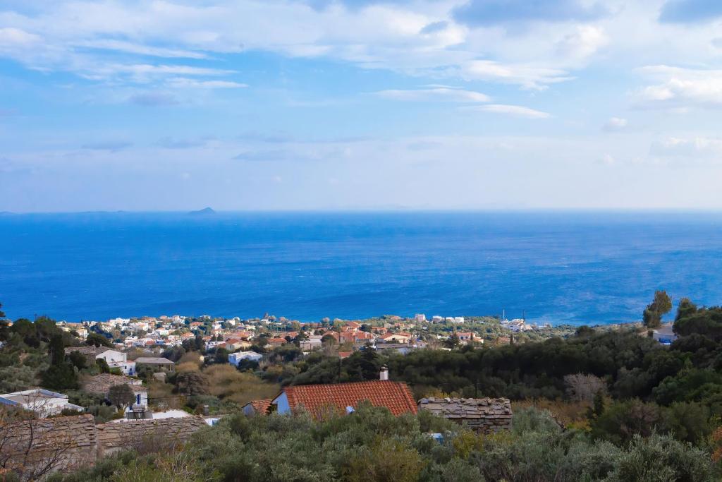 a view of a town with the ocean in the background at Tsapelas Villas in Agios Kirykos