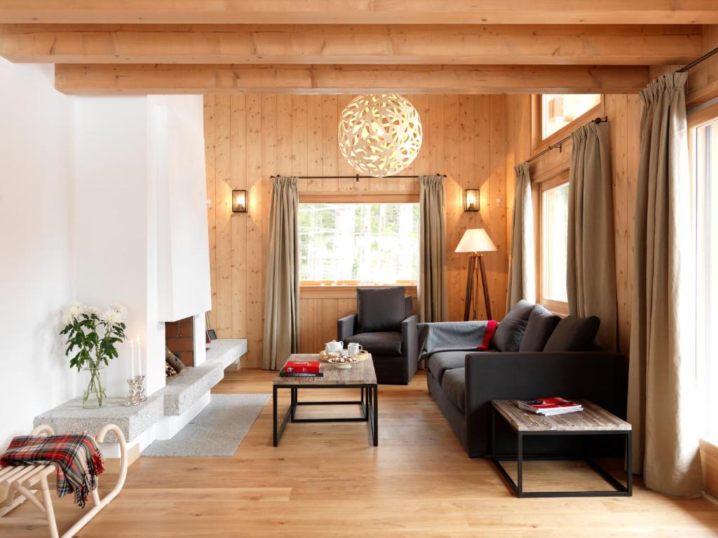 a living room with a couch and a table at Les Chalets des Liarets in Chamonix