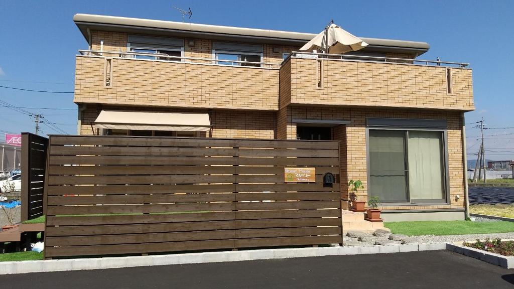 a house with a wooden fence in front of it at Guest House Mulberry - Vacation STAY 9580 in Kirishima