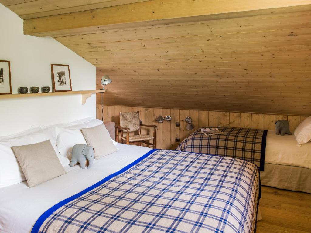 a bedroom with a bed with a teddy bear on it at Les Chalets des Liarets in Chamonix