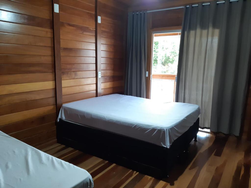 a bedroom with two beds and a window at Linda casa 3 quartos Castelhanos ES in Anchieta