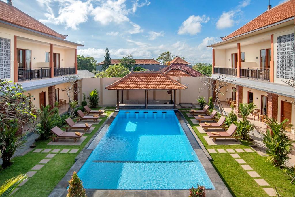 an image of a swimming pool in the backyard of a house at Tom's Inn Pecatu in Uluwatu