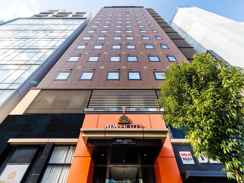 a tall building with an amazon hotel sign on it at APA Hotel Mita-Ekimae in Tokyo