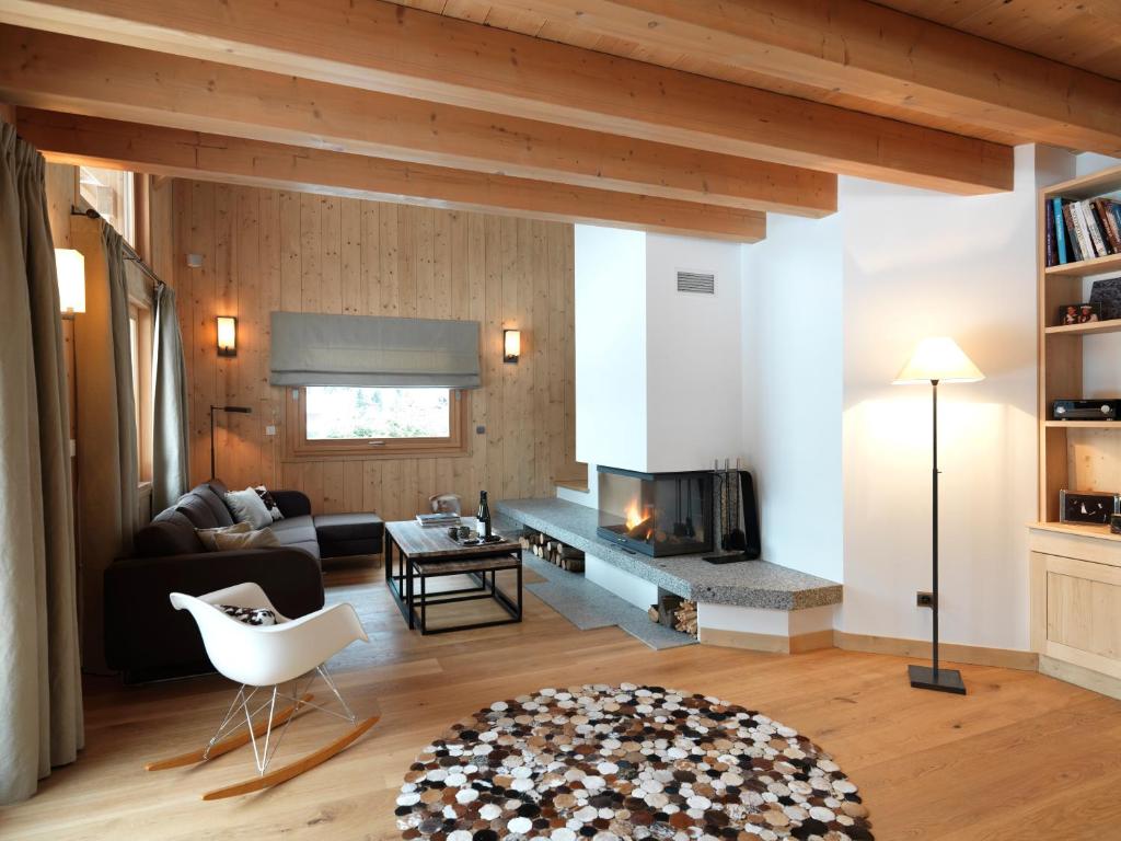 a living room with a couch and a fireplace at Les Chalets des Liarets in Chamonix
