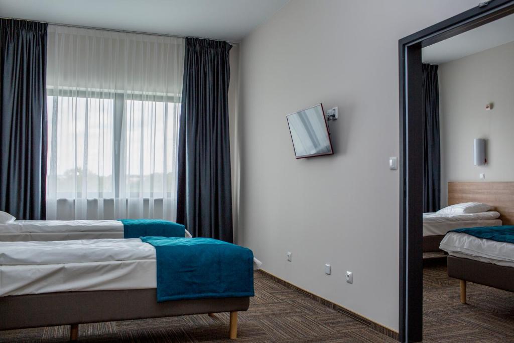 Posteľ alebo postele v izbe v ubytovaní Hotel Meeting
