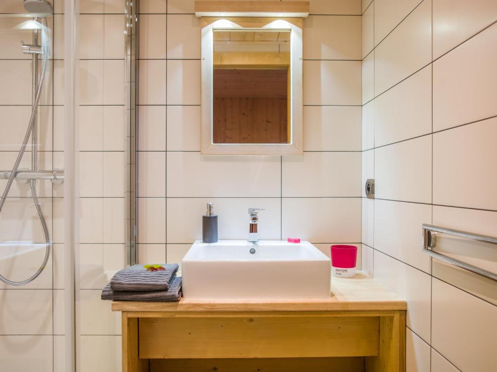 a bathroom with a white sink and a shower at Les Chalets des Liarets in Chamonix