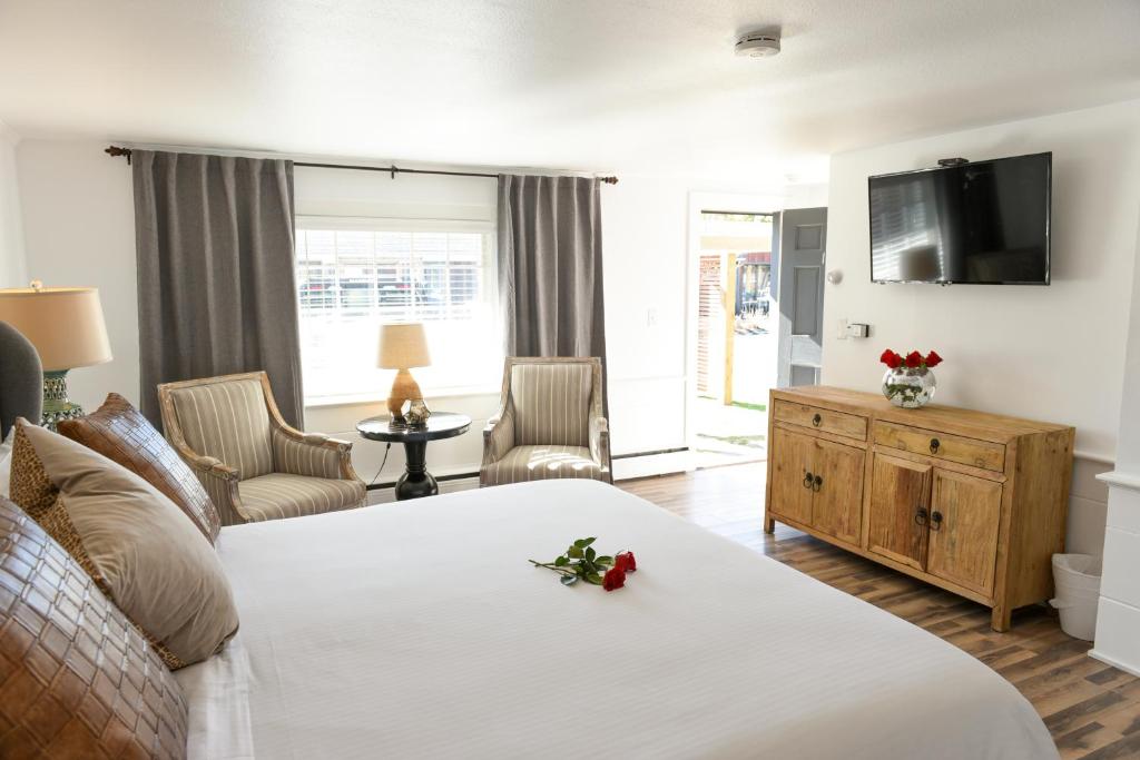 a hotel room with a bed and a tv at Cape Cod Veranda in South Yarmouth