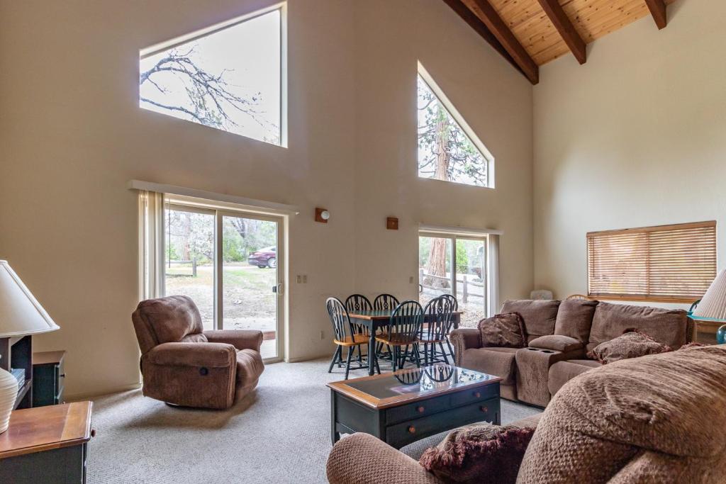 a living room with a couch and a table and chairs at Streiff Lake House in Bass Lake