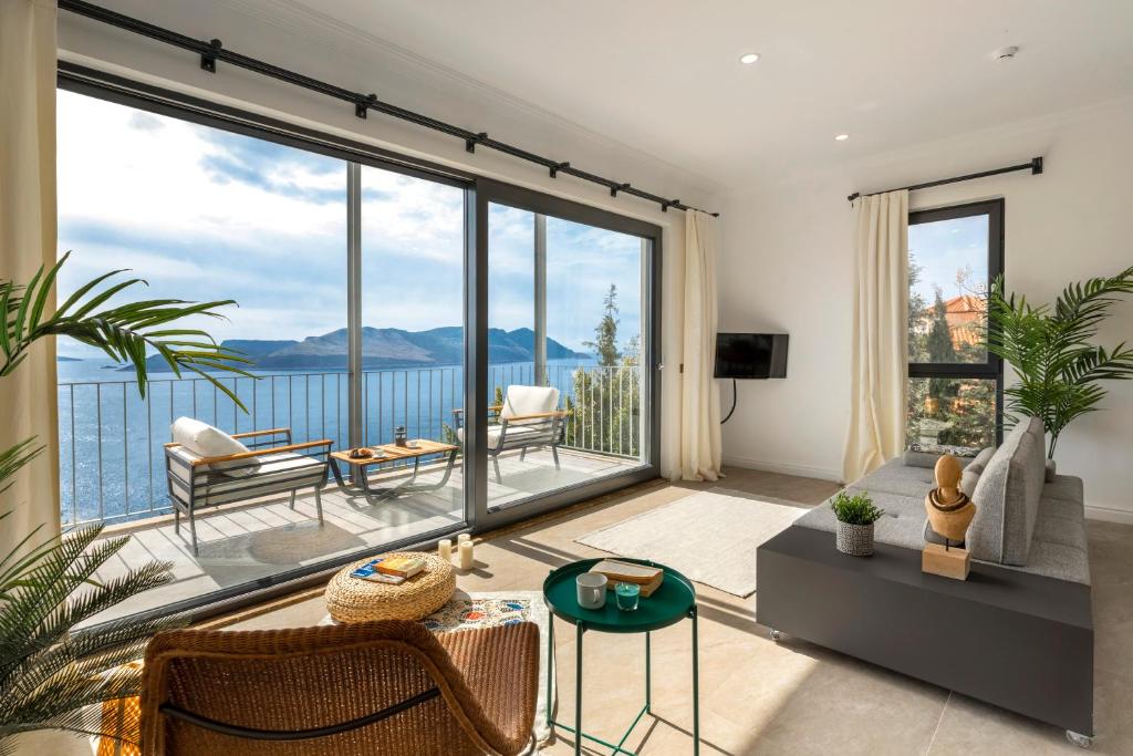 a living room with a view of the water at Born in Blue in Kaş