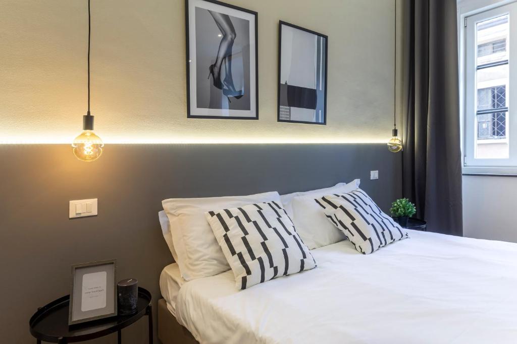 a bedroom with a white bed with two pillows at Amazing studio in the city center + WiFi in Trieste