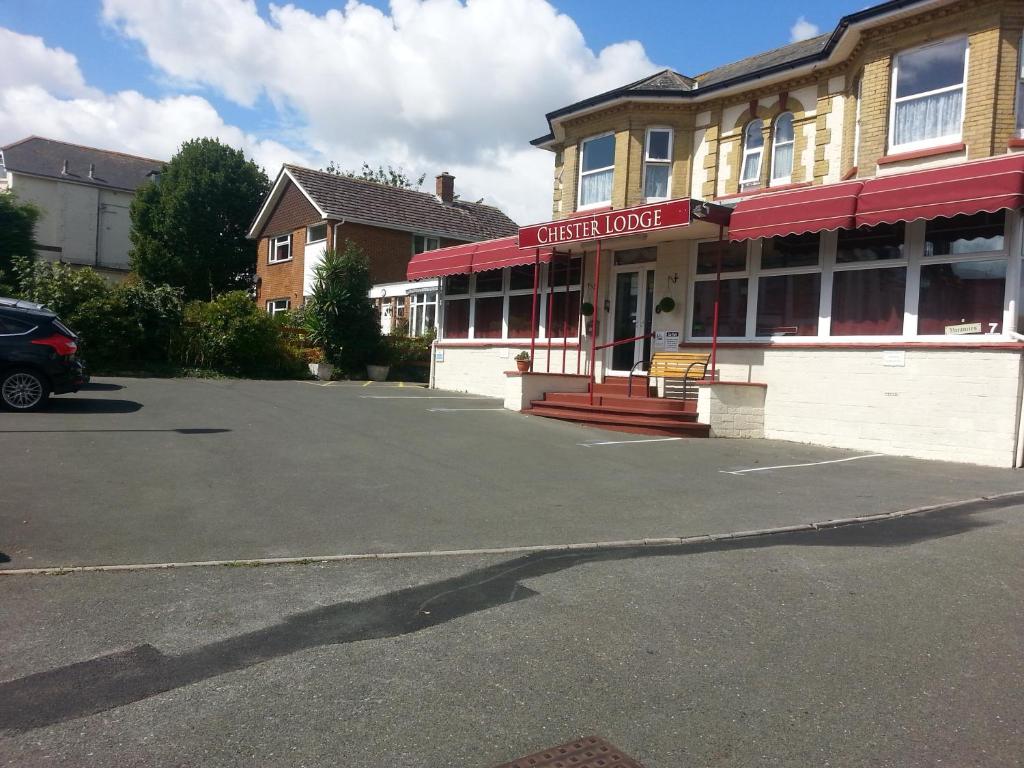 a car parked in a parking lot in front of a building at Chester Lodge in Sandown