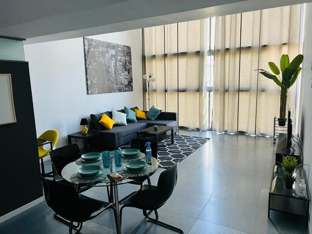 a living room with a table and a couch at Loft Confort in Alcalá de Henares