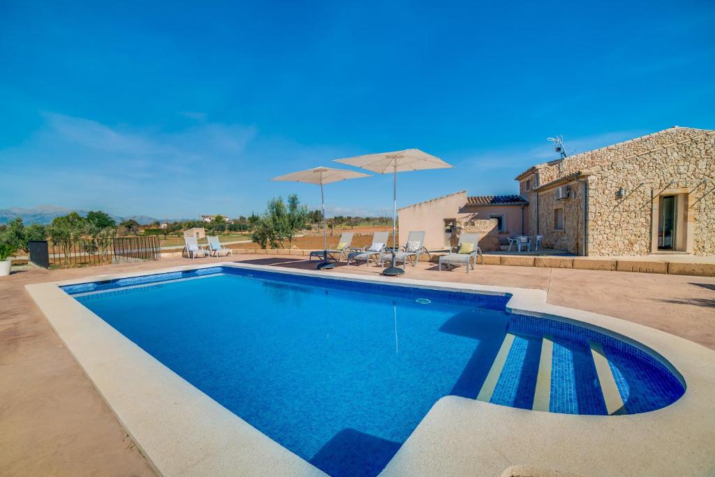 a swimming pool in front of a house at Ideal Property Mallorca - Brivo in Sencelles