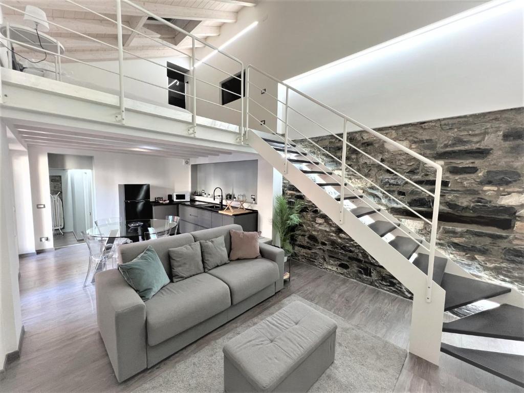 a living room with a couch and a staircase at Blue Diamond Como in Como