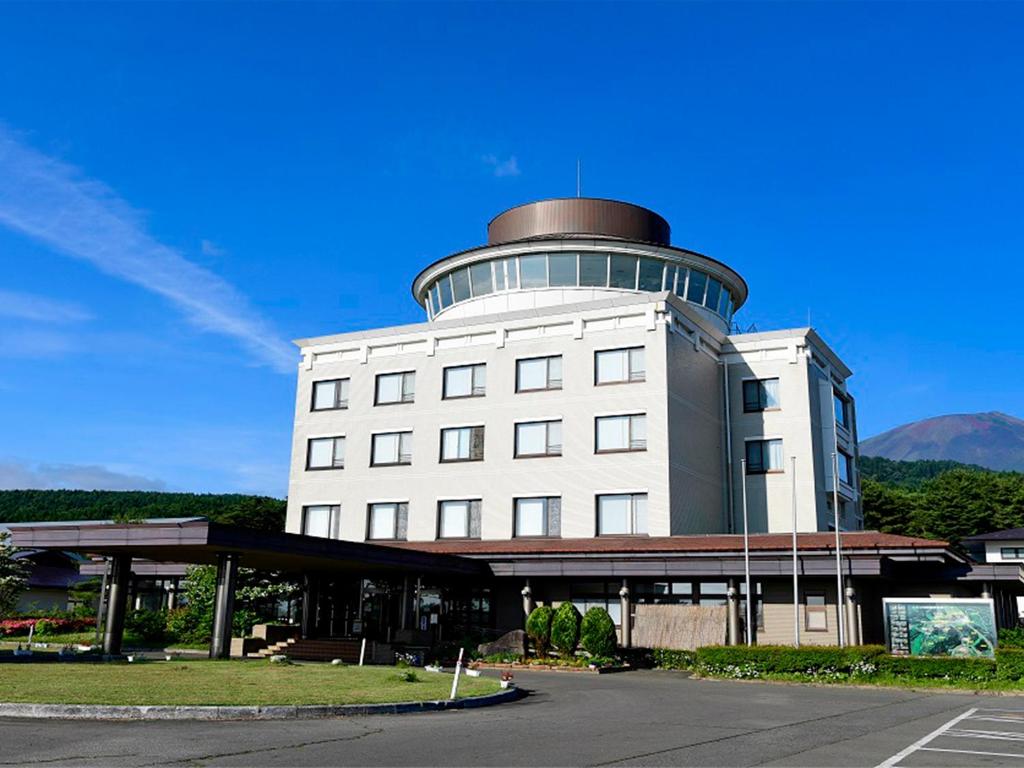a white building with a round tower on top of it at Ikoinomura Iwate in Hachimantai