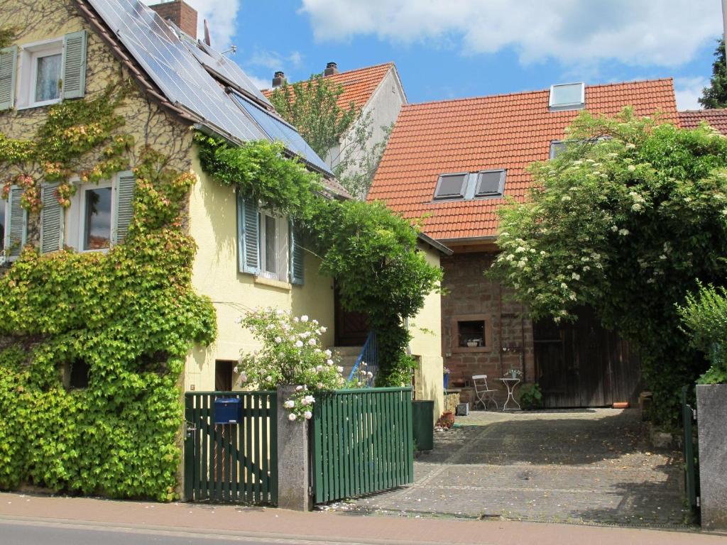 a house with a green fence in front of it at Ferienwohnung-Spessart in Straßbessenbach