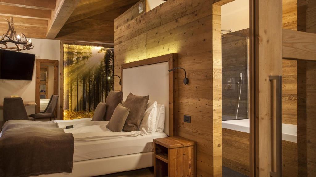 Postel nebo postele na pokoji v ubytování Boutique Hotel e Chalets Salvadori