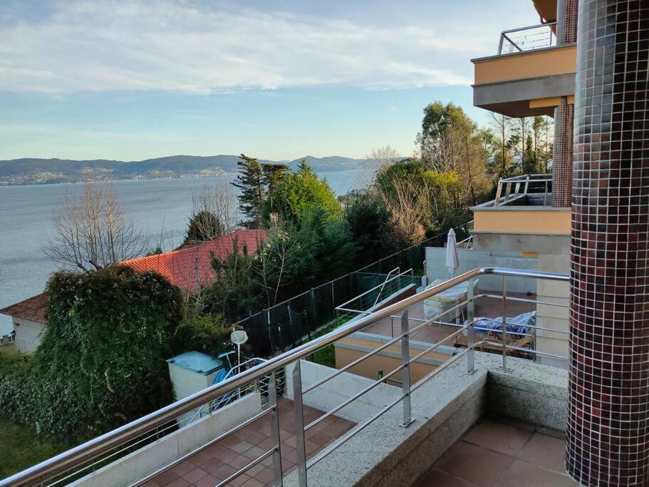 a balcony of a house with a view of the water at Precioso piso al lado de las playas en Portonovo in Sanxenxo
