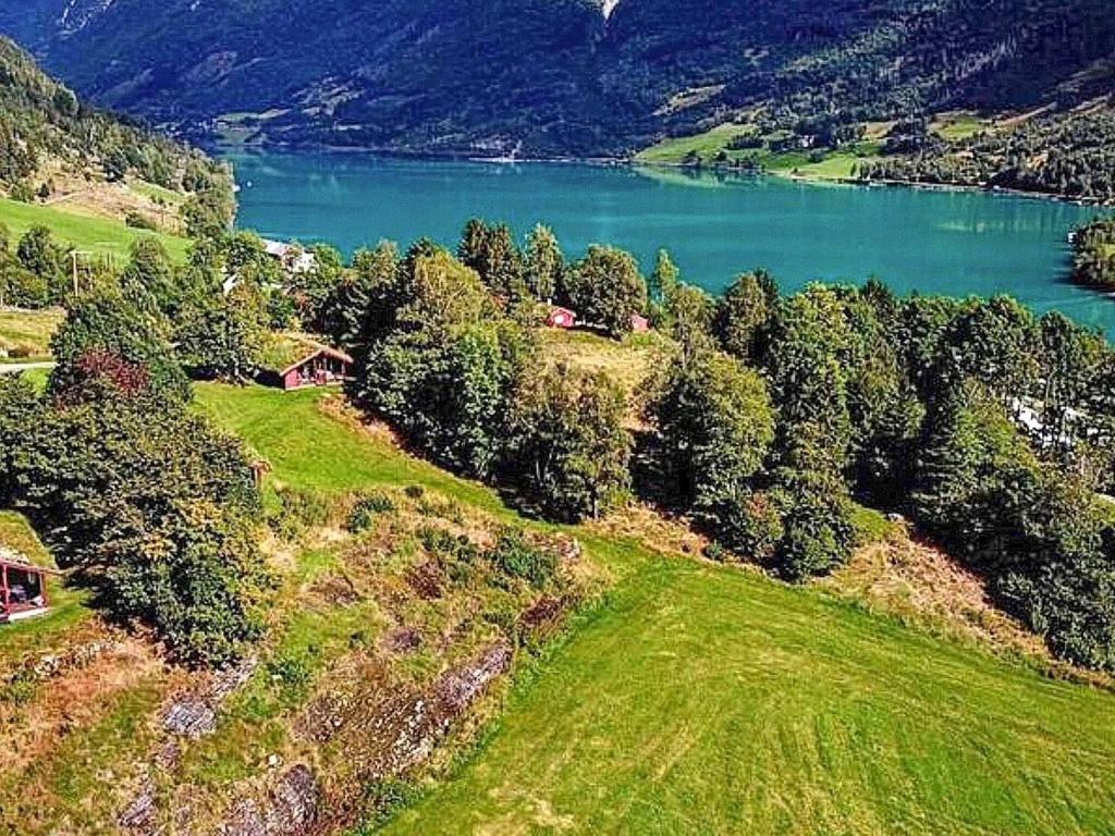 an aerial view of a house on a hill next to a lake at 6 person holiday home in olden-By Traum in Olden