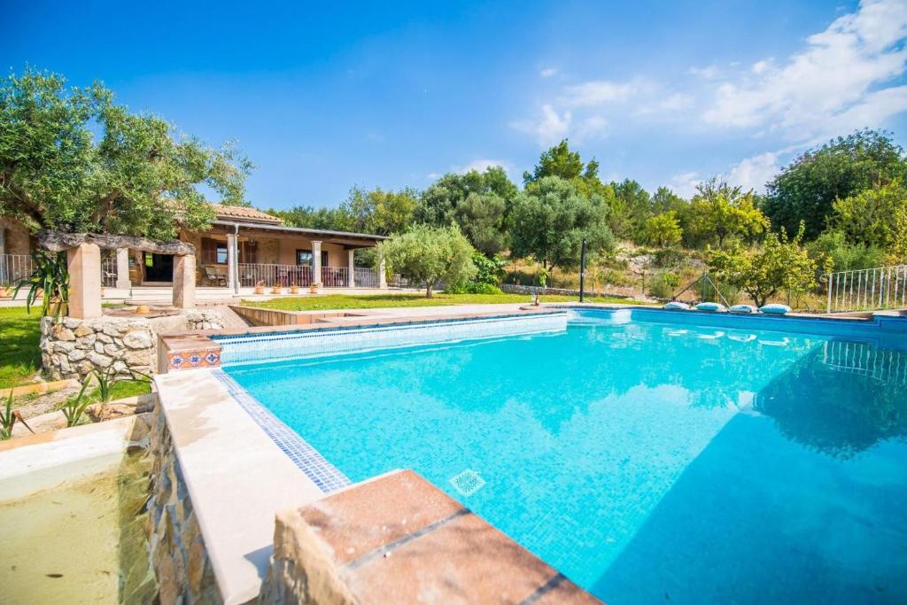 a swimming pool in a yard with a house at Ideal Property Mallorca - Ses Comes in Selva