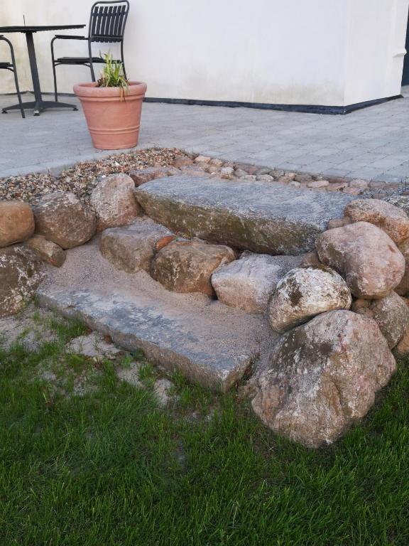 a stone path with rocks and a bench on a patio at Bøgehus in Vejle