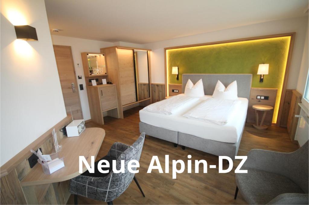 a hotel room with a bed and a table and chairs at Genuss- und Wellnesshotel Bercher in Waldshut-Tiengen