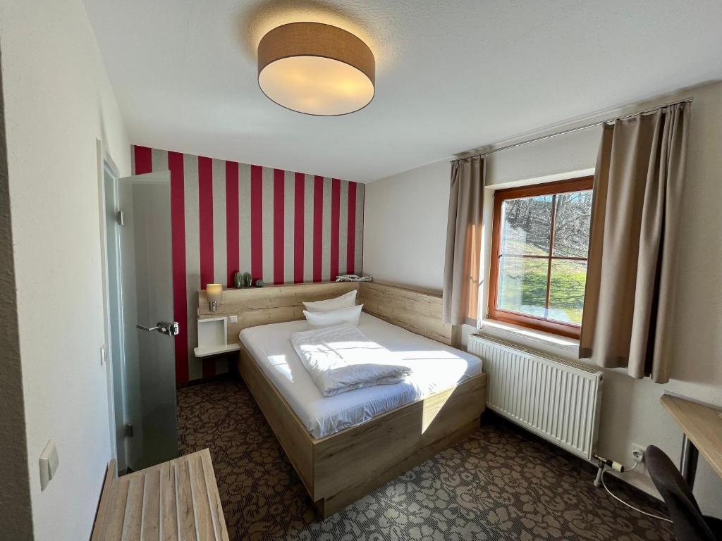Postel nebo postele na pokoji v ubytování Hotel in der Mühle