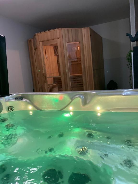 a tub filled with water with lights in a room at Aparthotel Des 2 Caps in Ambleteuse