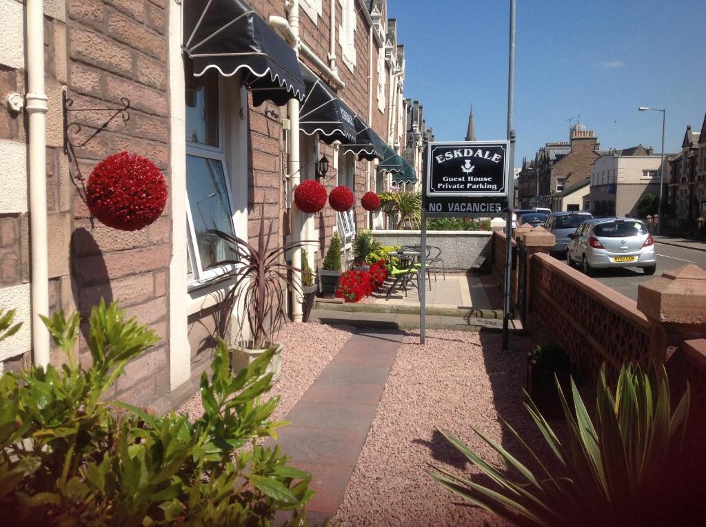 a building with a sign on the side of a street at Eskdale Guest House in Inverness