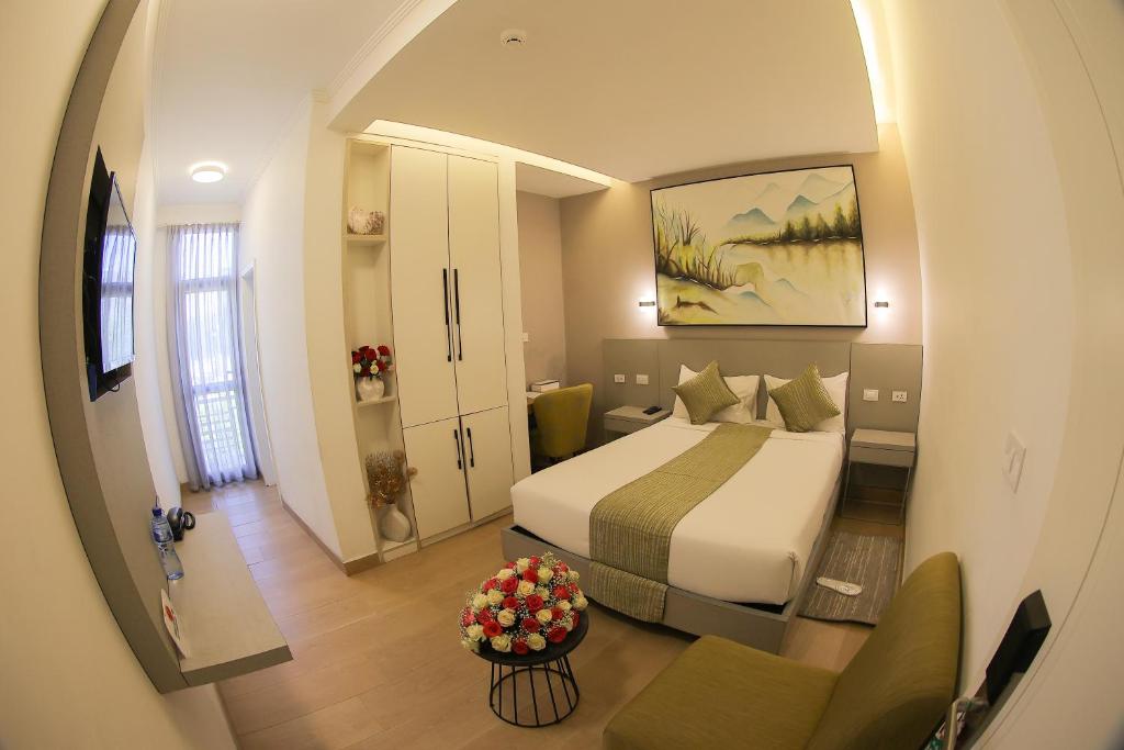 a bedroom with a bed and a living room at Andromeda Hotel in Addis Ababa