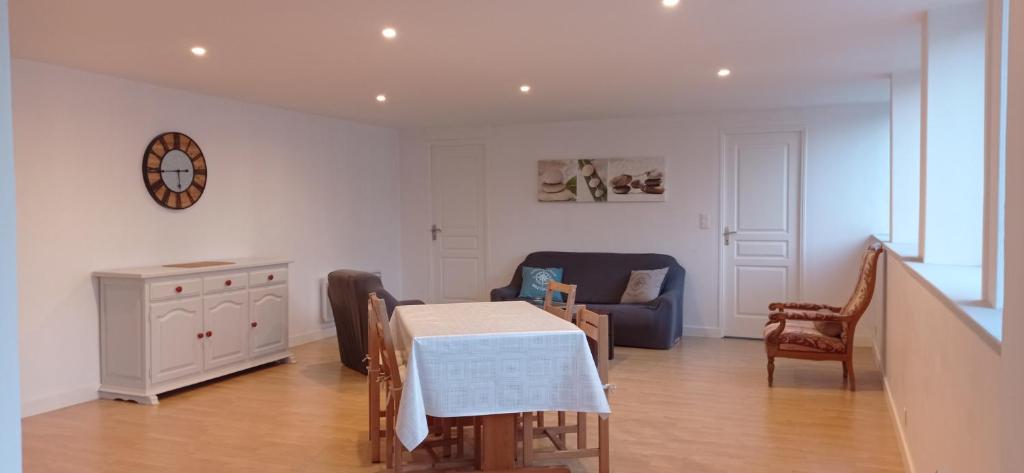 a living room with a table and a couch at La plage in Audierne