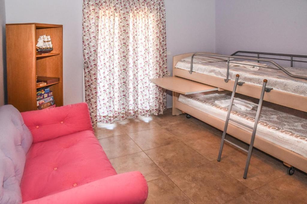 salon z łóżkiem piętrowym i kanapą w obiekcie Ambelaki Polythea w mieście Kardhoulianós