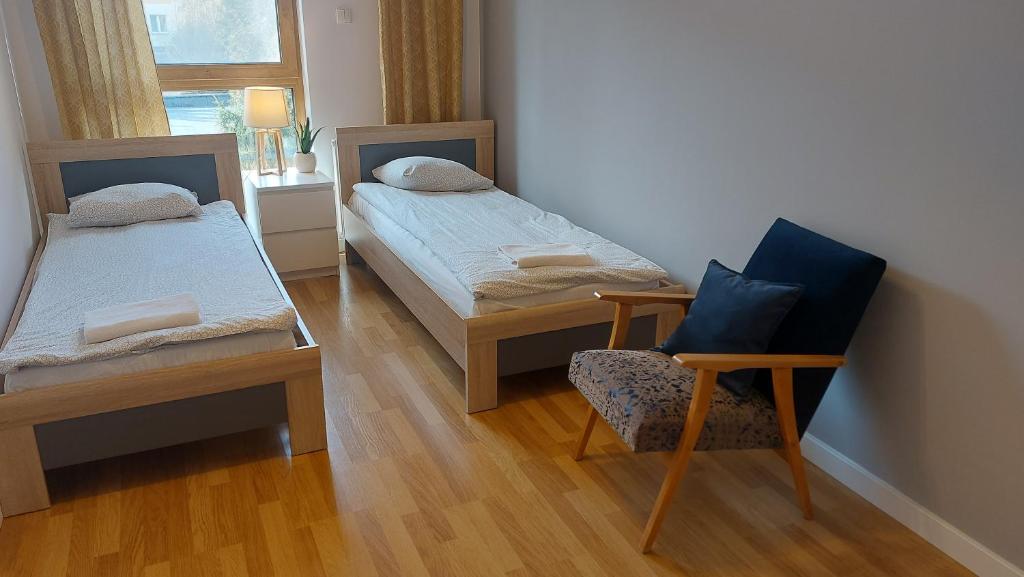 Posteľ alebo postele v izbe v ubytovaní Apartament Robinia z miejscem parkingowym