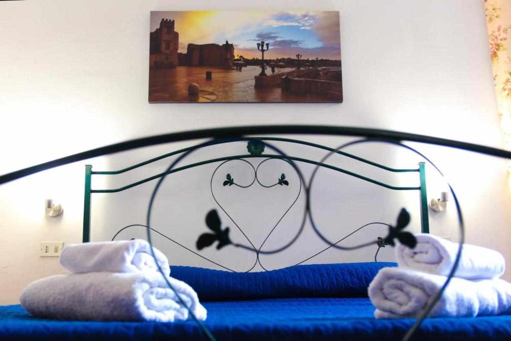 a bedroom with a blue bed with birds on it at Lo Spioncino Apartments in Otranto