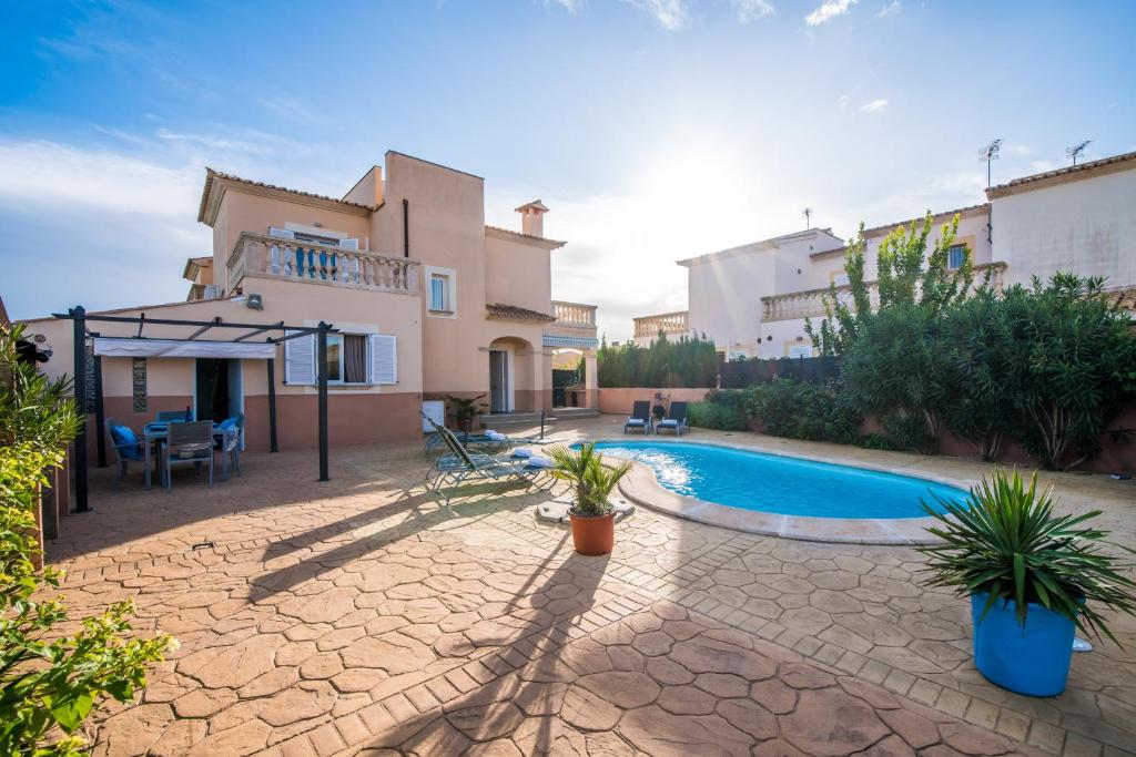 eine Villa mit Swimmingpool und ein Haus in der Unterkunft Ideal Property Mallorca - Son Moleto in Sa Ràpita