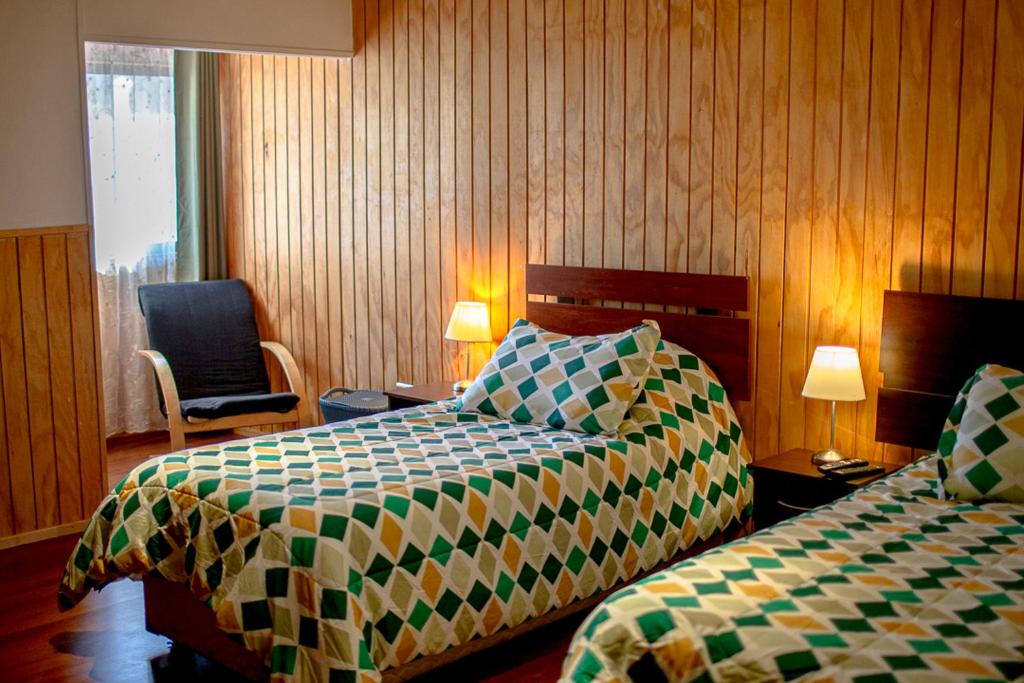En eller flere senger på et rom på Roble Austral Hostal