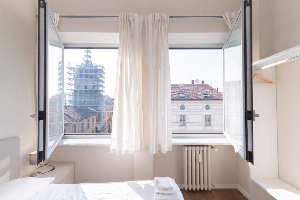 Łóżko lub łóżka w pokoju w obiekcie Via Torino Apartment 3