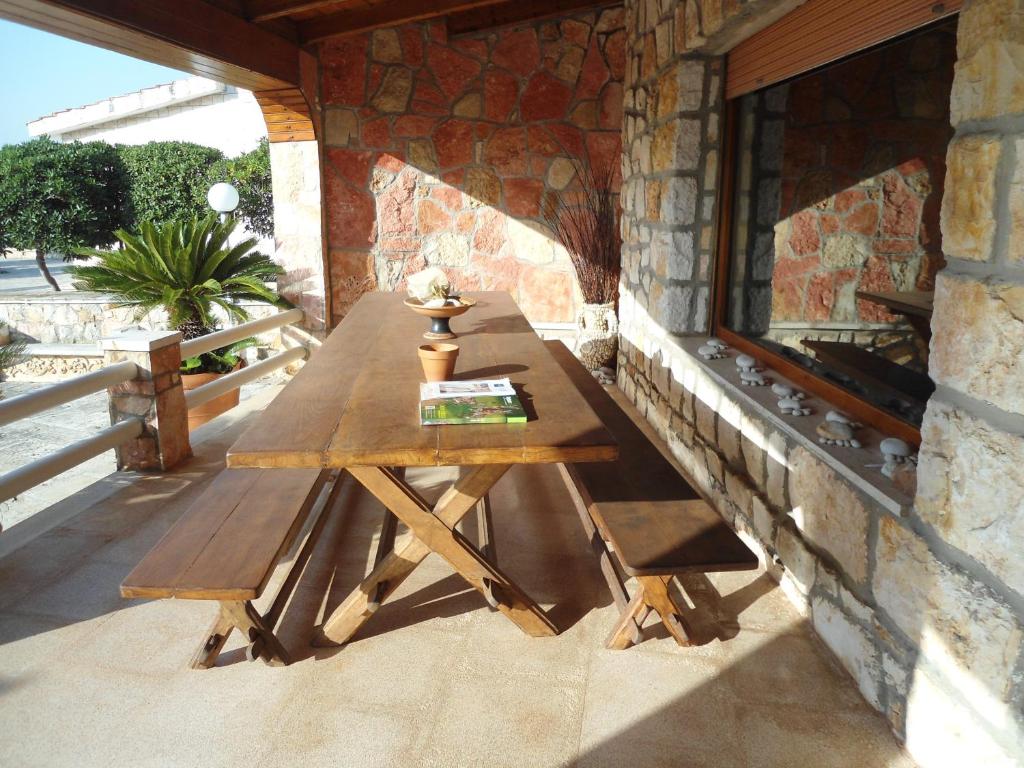 a wooden table sitting on the side of a building at Ville Alba & Azzurra in Polignano a Mare