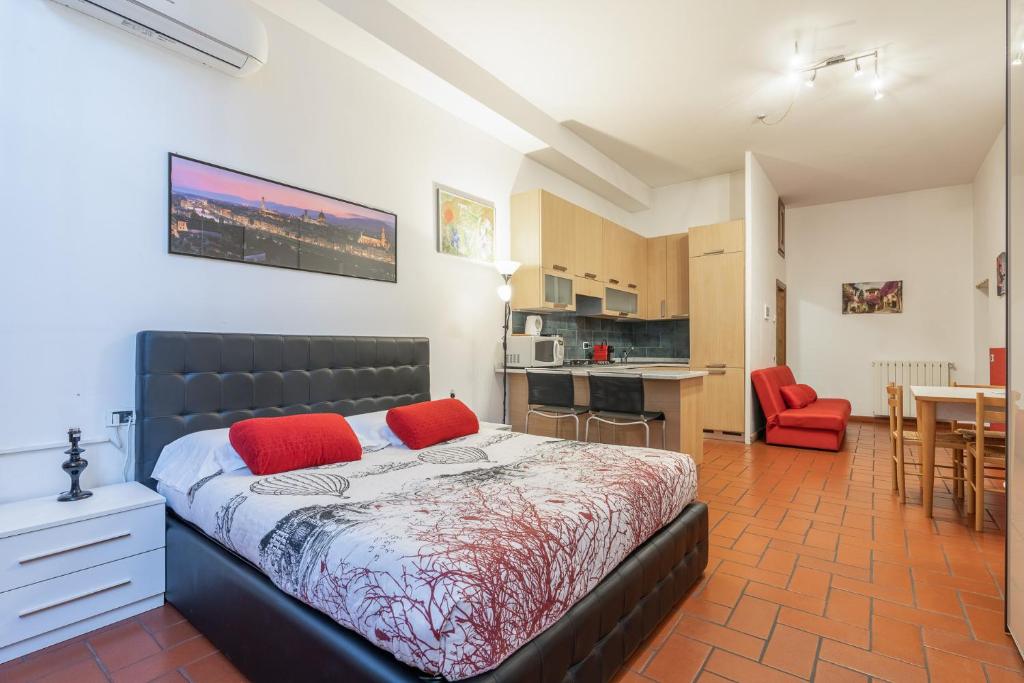 Un dormitorio con una cama con almohadas rojas. en Firenze Rentals Suite Oche, en Florencia