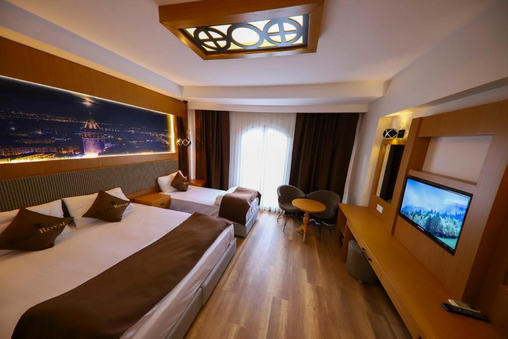 a hotel room with two beds and a flat screen tv at Ruby Royal in Istanbul