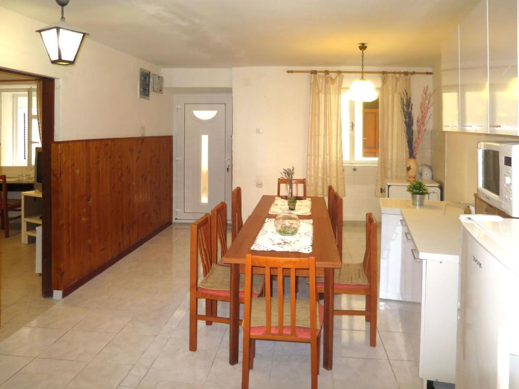 a kitchen and dining room with a table and chairs at Holiday Home Helena - Pag310 by Interhome in Pag