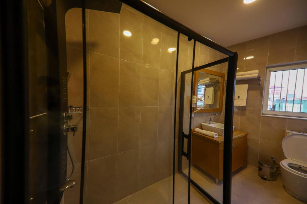 a bathroom with a shower with a toilet and a sink at Ruby Royal in Istanbul