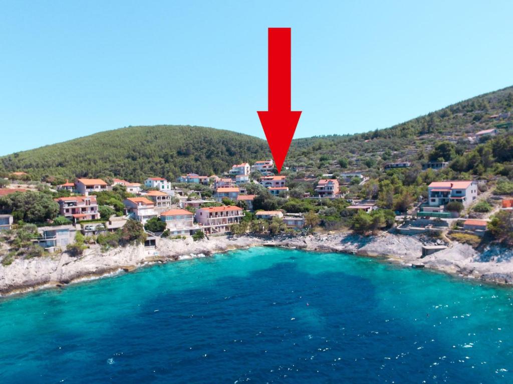 a red arrow pointing to a small town on a beach at Apartment Haus Peric - KOR200 by Interhome in Prigradica