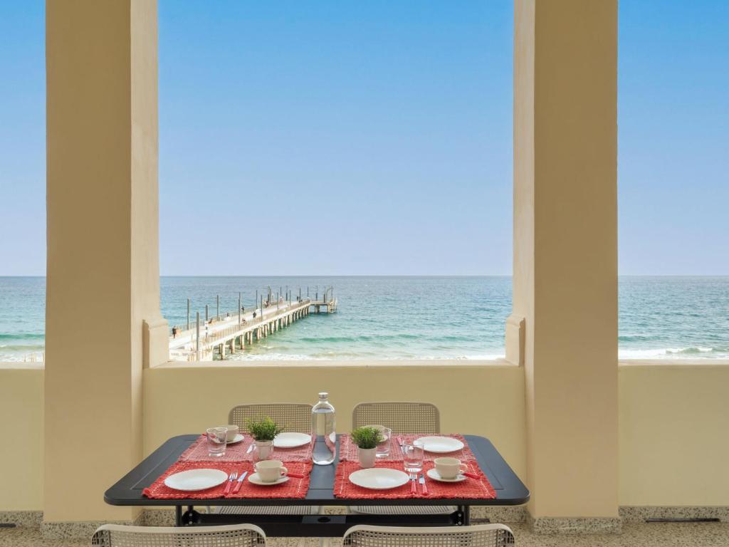 a dining table with a view of the ocean at Apartment Terrazza sul Molo by Interhome in Alassio