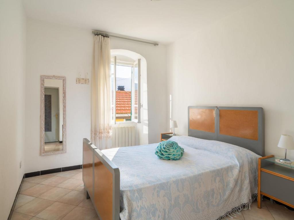 sypialnia z łóżkiem, lustrem i oknem w obiekcie Apartment Caruggiu - PTB193 by Interhome w mieście Pietrabruna