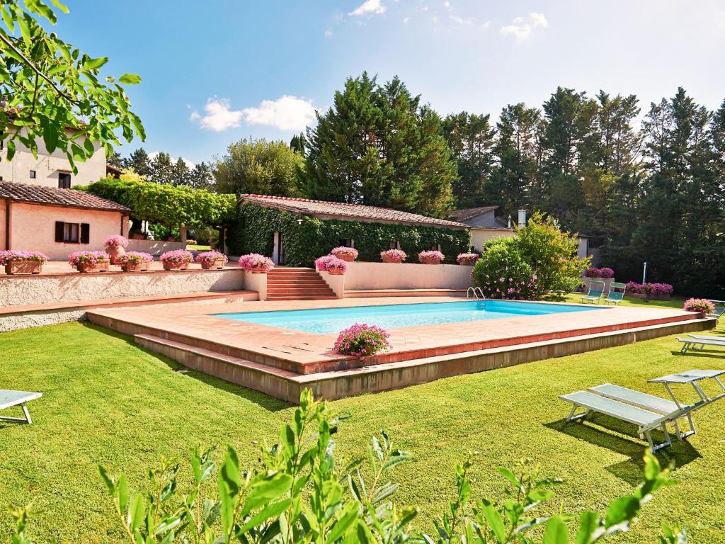 a swimming pool in a yard with a lawn at Holiday Home Bardeggiano - Caterina 5 by Interhome in Belvedere
